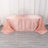 Pink striped tablecloth draped over a table in a studio setting.