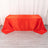 Red striped tablecloth draped over a table in a studio setting.