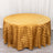Round gold striped tablecloth on a plain backdrop.