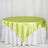 Round table with a lime green satin tablecloth and white skirt.