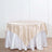 Round table with a satin beige tablecloth.