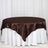 Brown satin tablecloth draped over a white table.