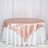 Blush satin tablecloth draping elegantly over a white table