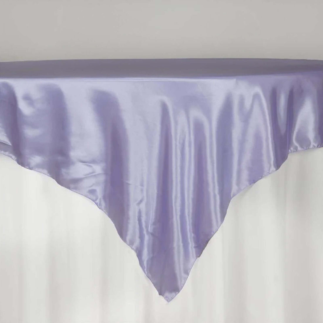 Lavender satin tablecloth draped elegantly over a table edge.