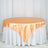 Orange satin tablecloth draped elegantly over a round table