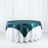 Teal satin tablecloth on a white table