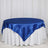 Blue satin tablecloth draped over a round table with white skirt