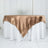 Satin tablecloth in gold draped over a white table