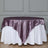Elegant purple satin table overlay on a round white table.