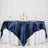 Elegant navy satin tablecloth draped over a white table with floral centerpiece.