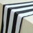 Black and white striped table runner on a plain surface.