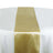Gold satin table runner on a white table. #whtbkgd