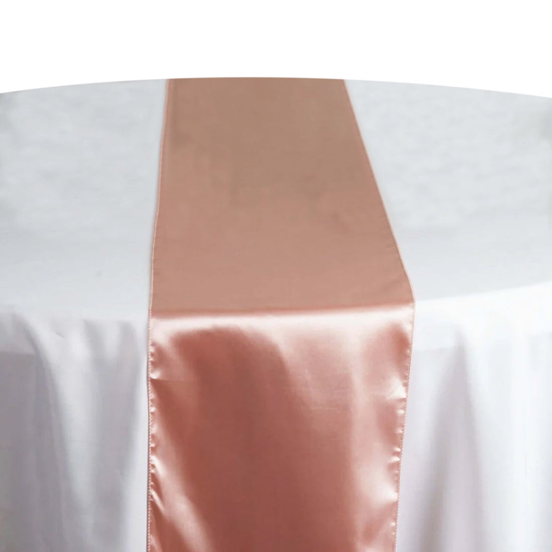 Rose gold satin table runner on a white tablecloth #whtbkgd