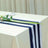 Navy and white striped table runner on a cream tablecloth.