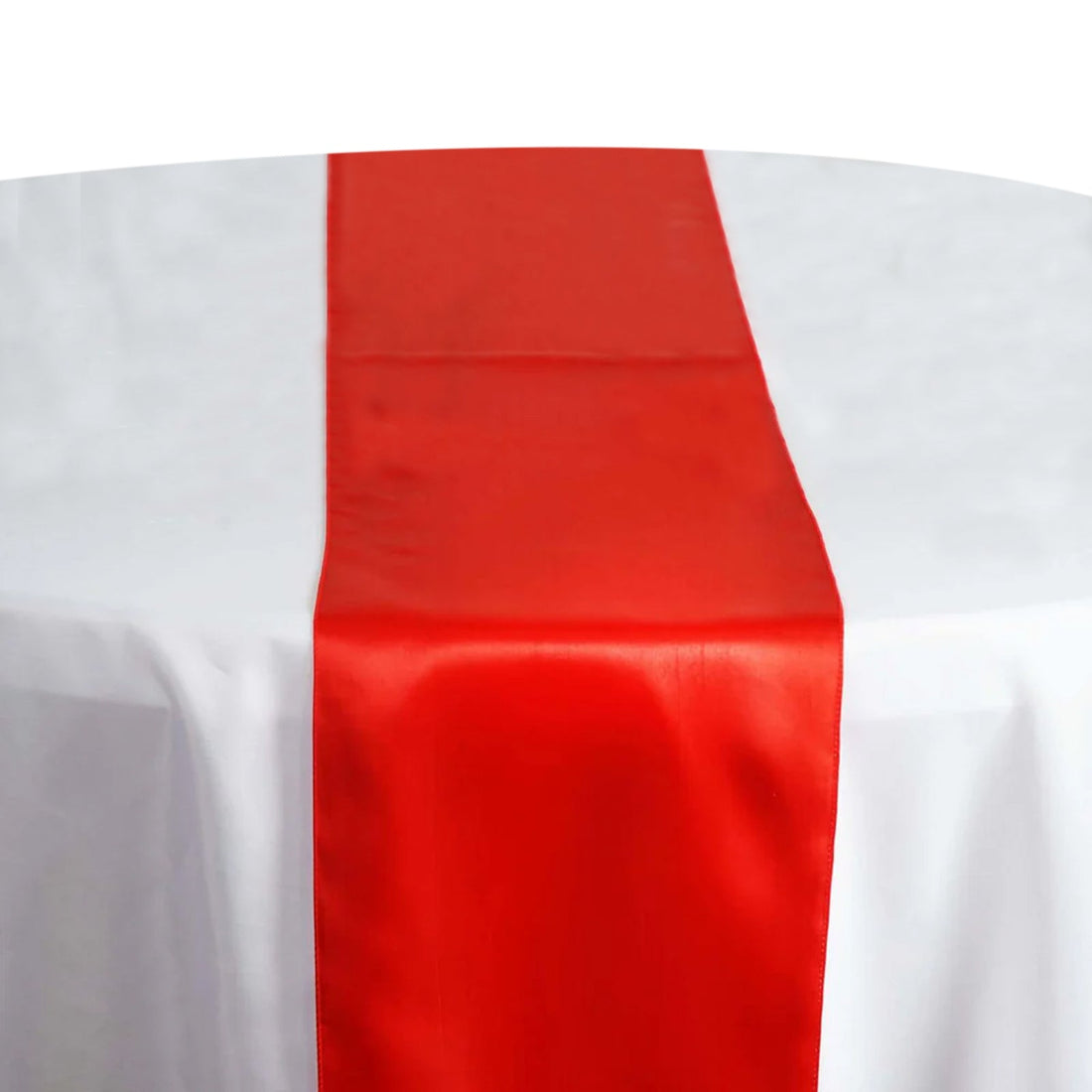 Red satin table runner on a white tablecloth. #whtbkgd