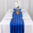 Blue striped table runner on a dining table with floral centerpiece and glassware.