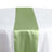 Green satin table runner on a white tablecloth #whtbkgd