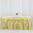 Gold table skirt draped elegantly over a table with floral centerpiece.