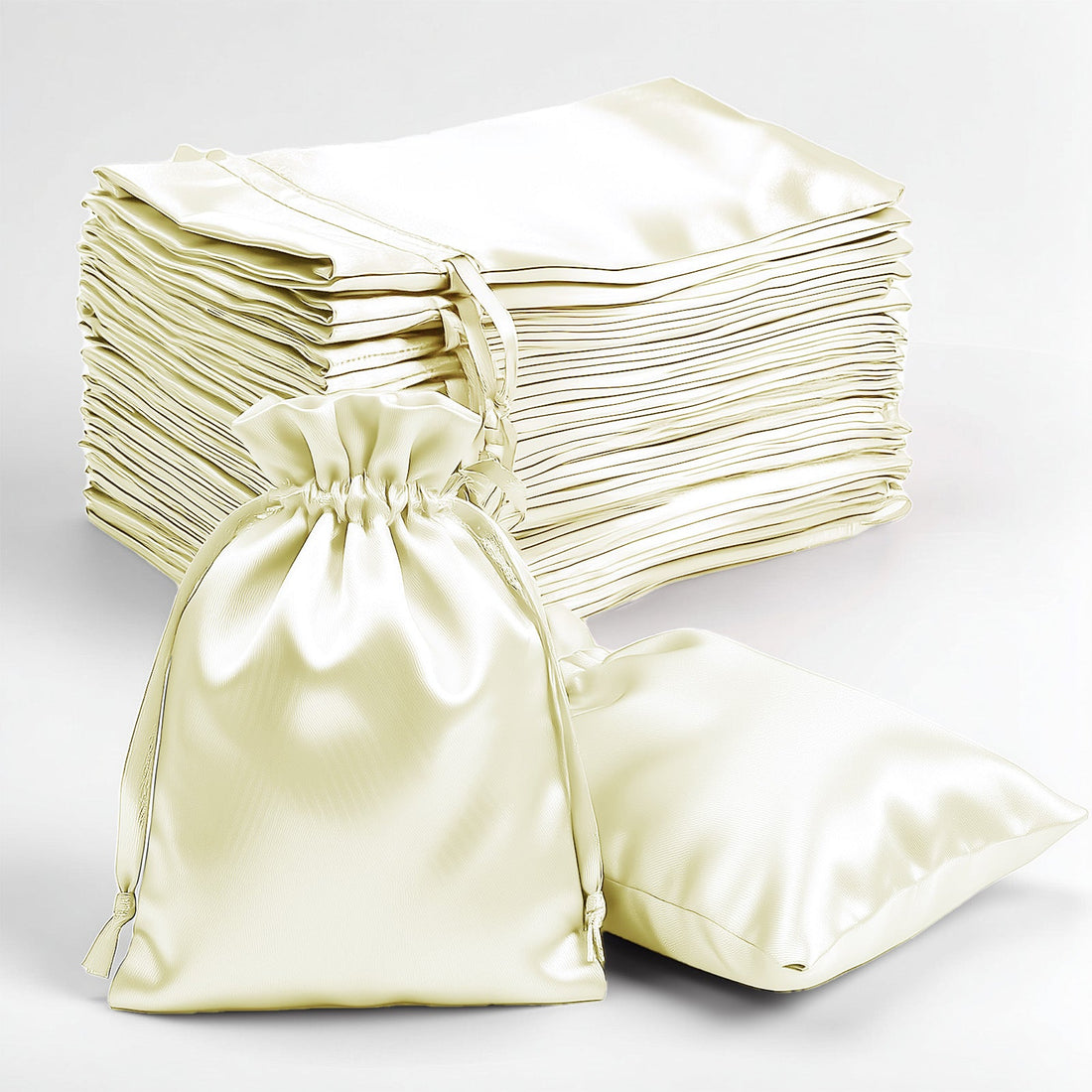 Set of elegant satin drawstring bags in cream color on a white background.