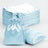 Stack of light blue satin bags and flat fabric sheets on a white background.