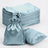 Stack of light blue satin bags and pillowcases on a white background.