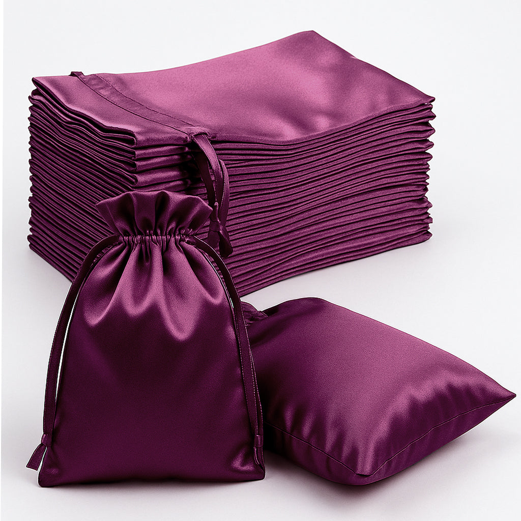 Set of purple satin drawstring bags on a white background.