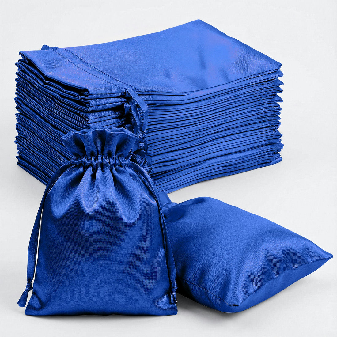 Stack of blue satin bags with one bag in the foreground.