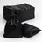 Black satin drawstring bags stacked with one bag and a pillow on a white background.