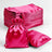 Stack of pink satin bags and pouches on a white background.