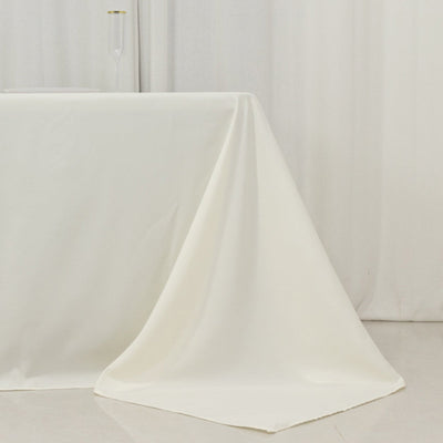 White tablecloth draping elegantly over a table in a minimalist setting.