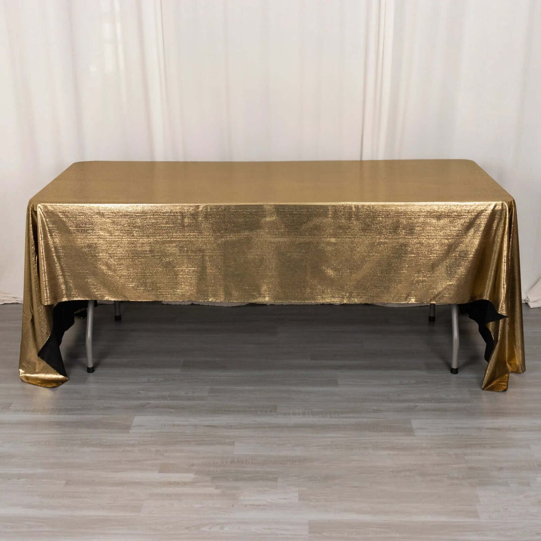 Gold tablecloth draped over a rectangular table.