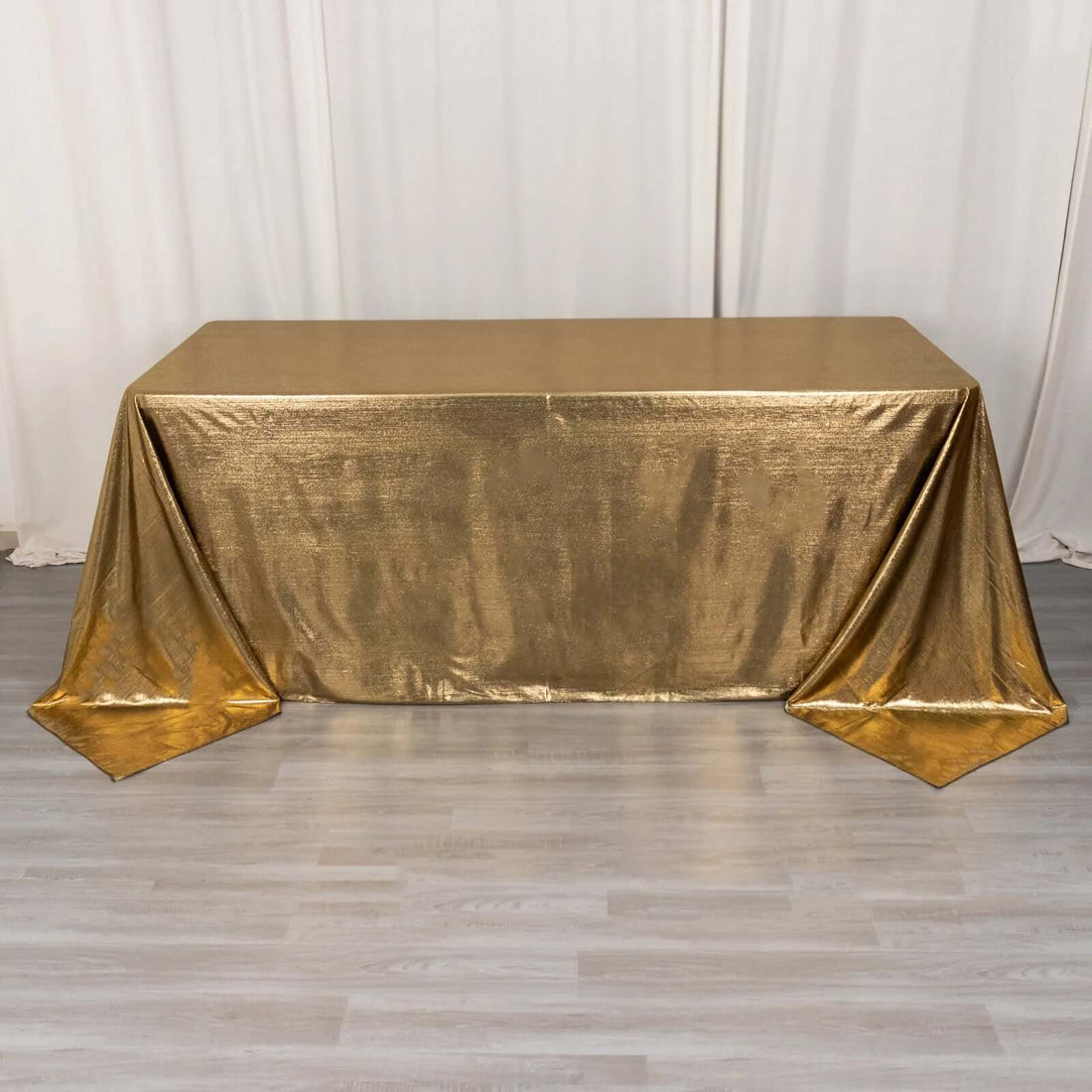 Gold tablecloth with a shimmering finish draped elegantly over a table.