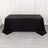 Black table draped with a sleek tablecloth for event styling.