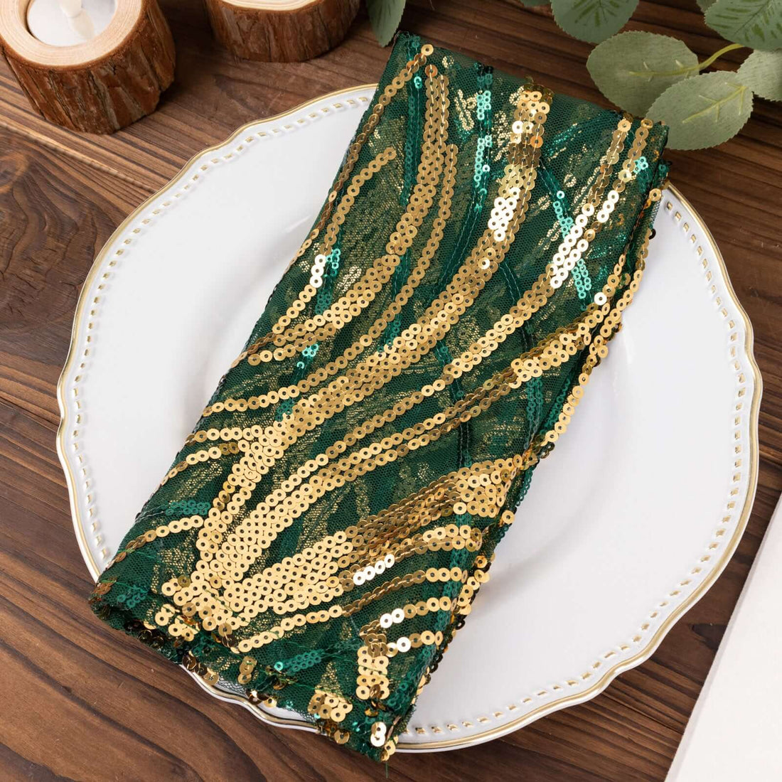 Green and gold sequin table napkin on a decorative plate.