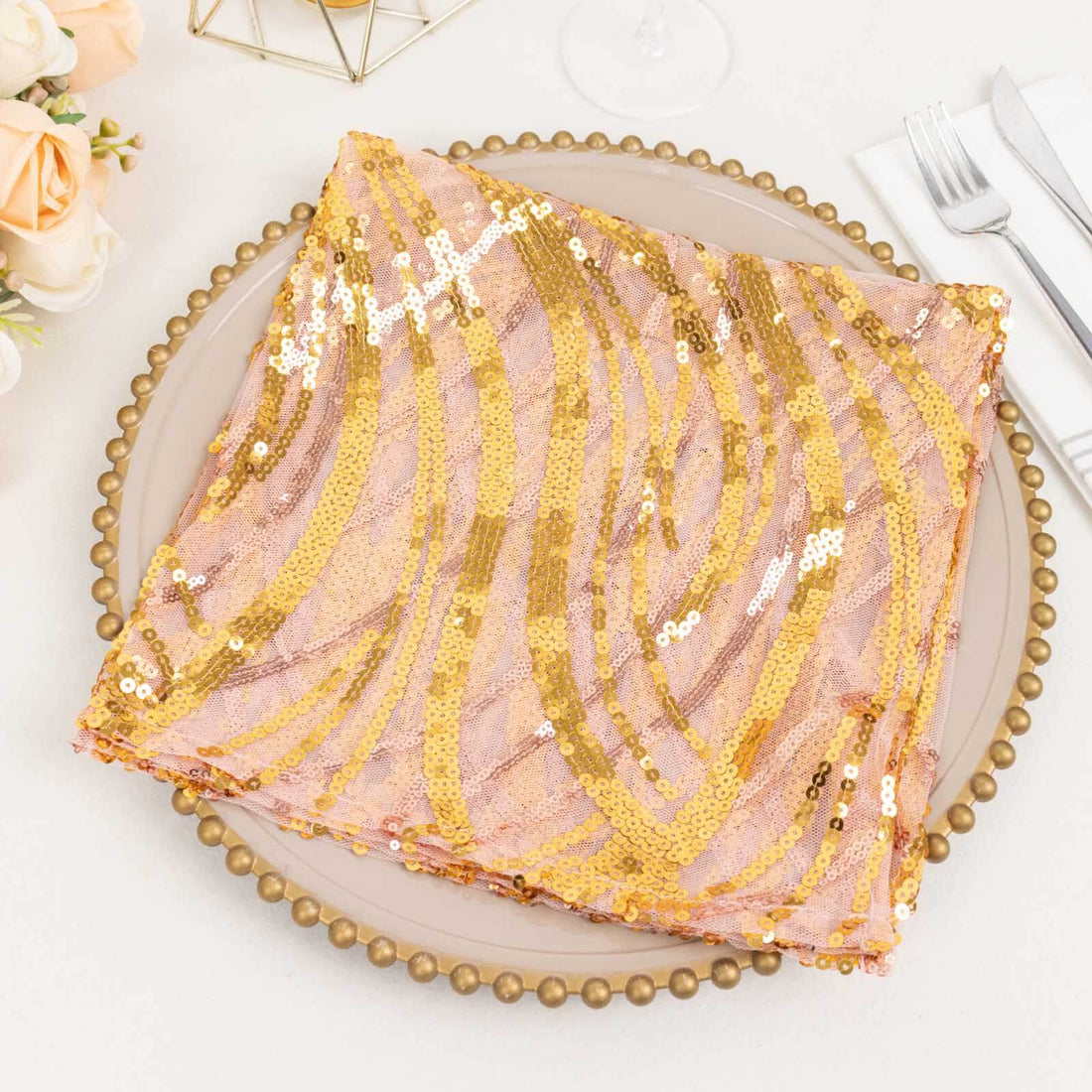 Pink and gold sequined tablecloth on a decorative plate.