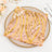 Pink and gold sequined tablecloth on a decorative plate.