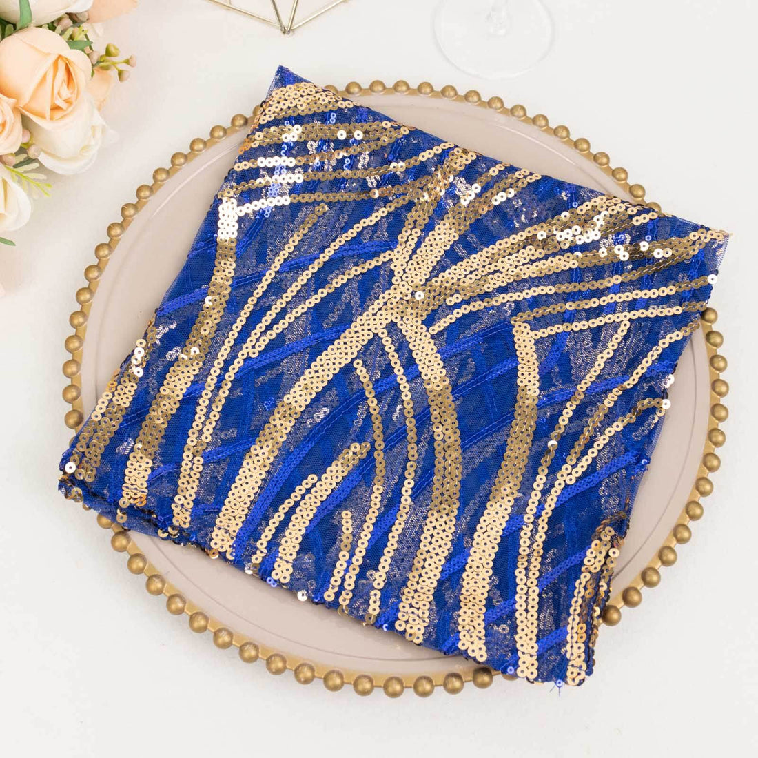 Blue and gold sequin fabric folded on a decorative plate.