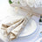 Elegant gold sequin napkin with crystal holder on a white plate.