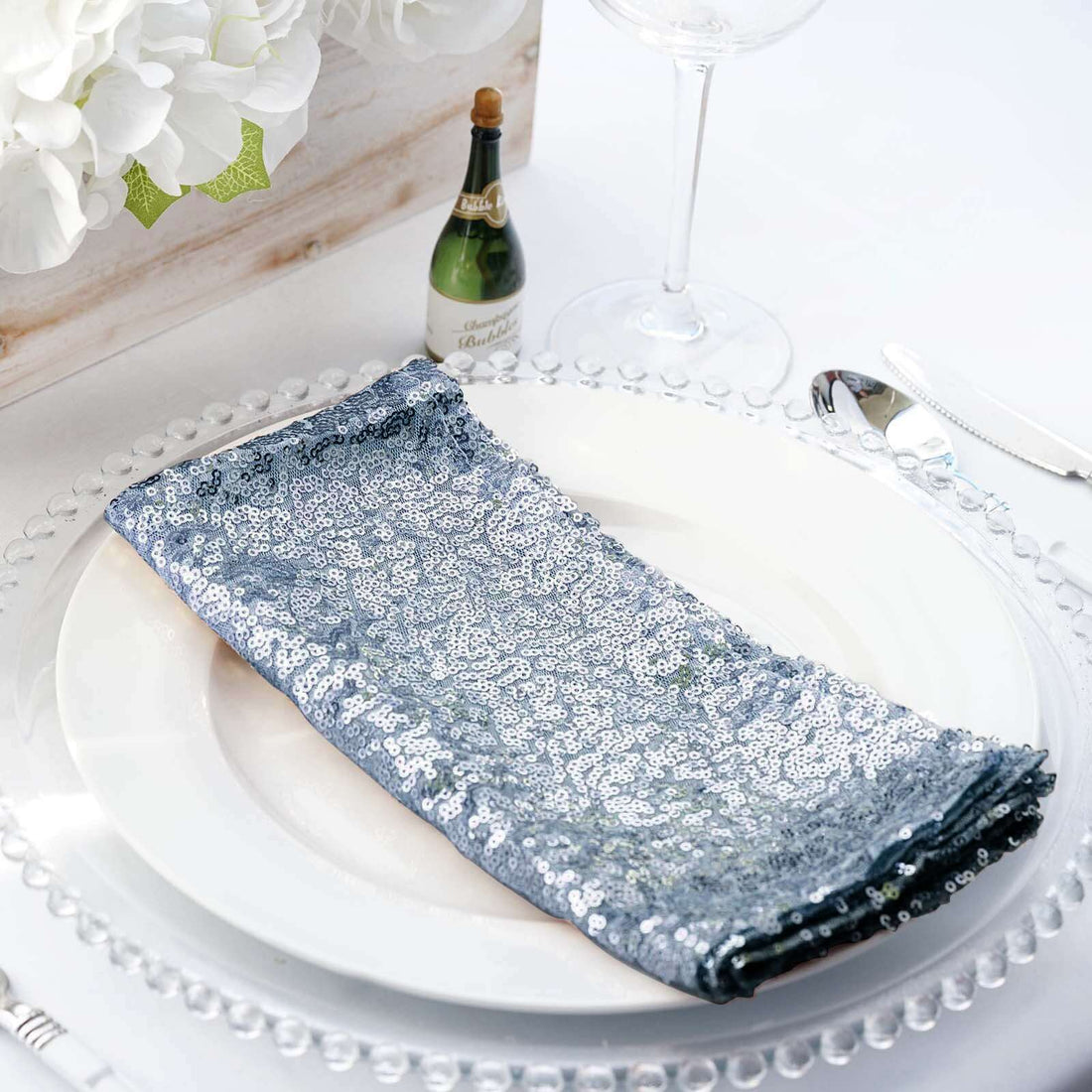Sequin table napkin on a plate with elegant dining setup