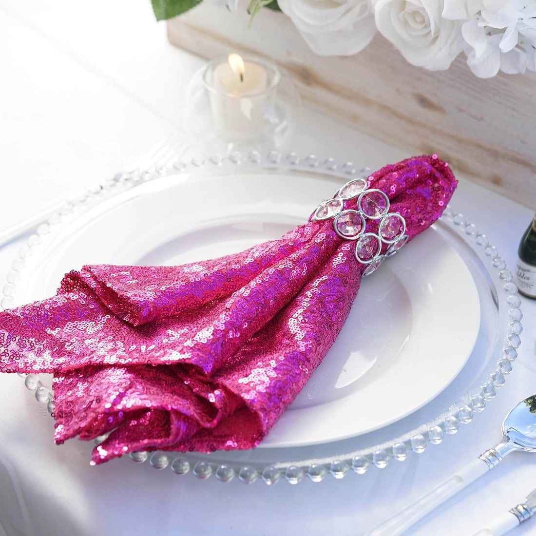 Sparkling pink sequin napkin elegantly arranged on a dining plate.