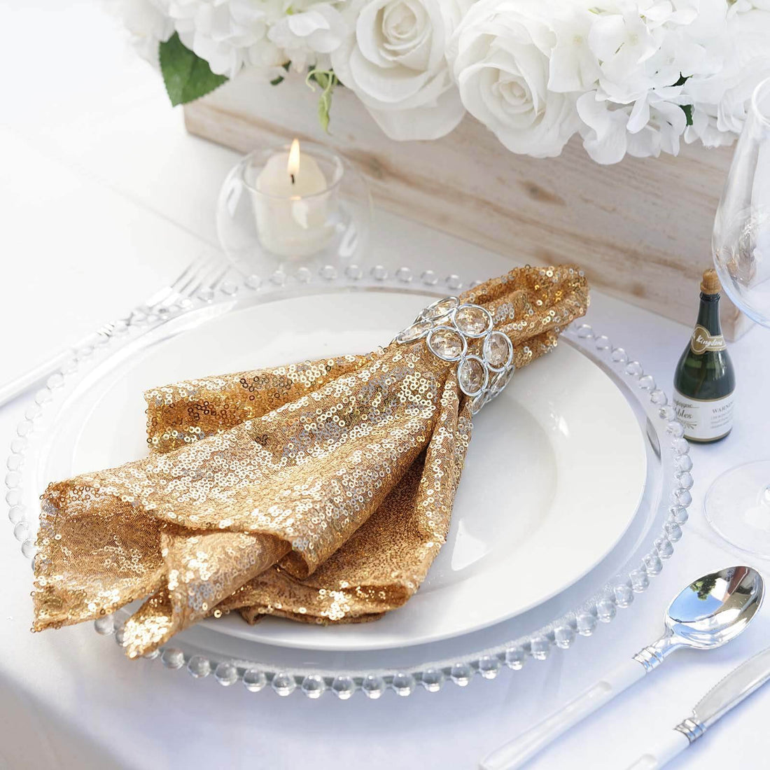 Gold sequin napkin elegantly styled on a plate with decorative table setting.