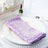 Purple sequin napkin elegantly placed on a white plate with decorative glassware.