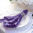 Purple sequin napkin elegantly styled on a white plate with crystal rim.