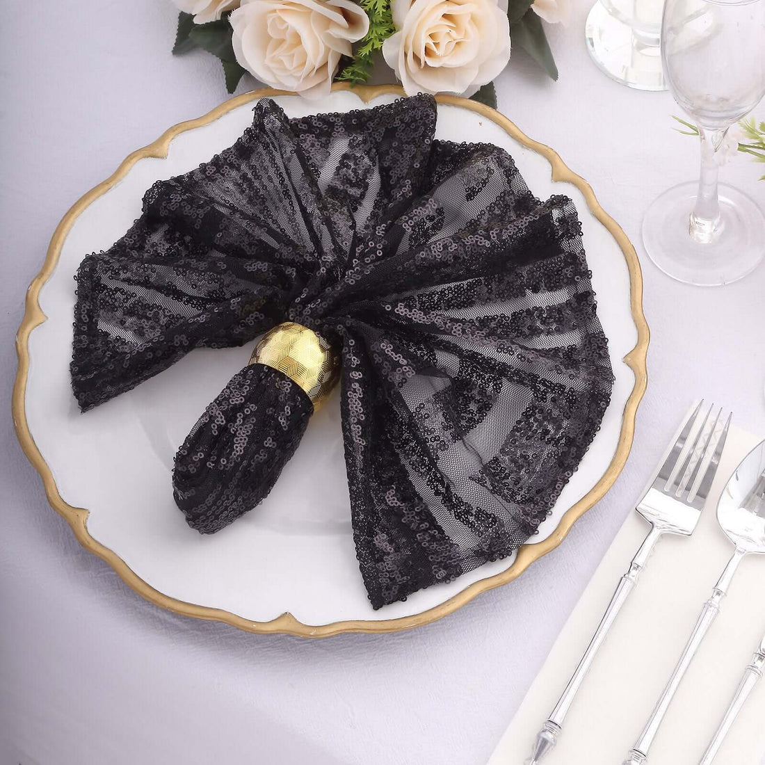 Elegant black sequined napkin on a decorative plate, perfect for formal dining.