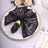 Elegant black sequined napkin on a decorative plate, perfect for formal dining.