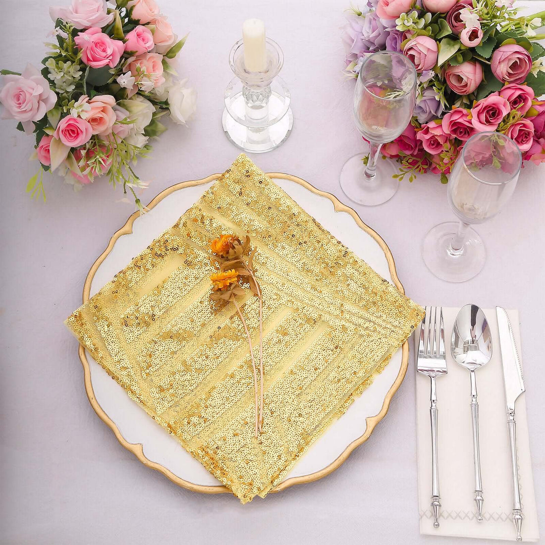 Elegant golden table napkin with floral decoration on a beautifully set dining table.