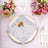 Elegant table setting with silver napkin, candle, and floral arrangements.