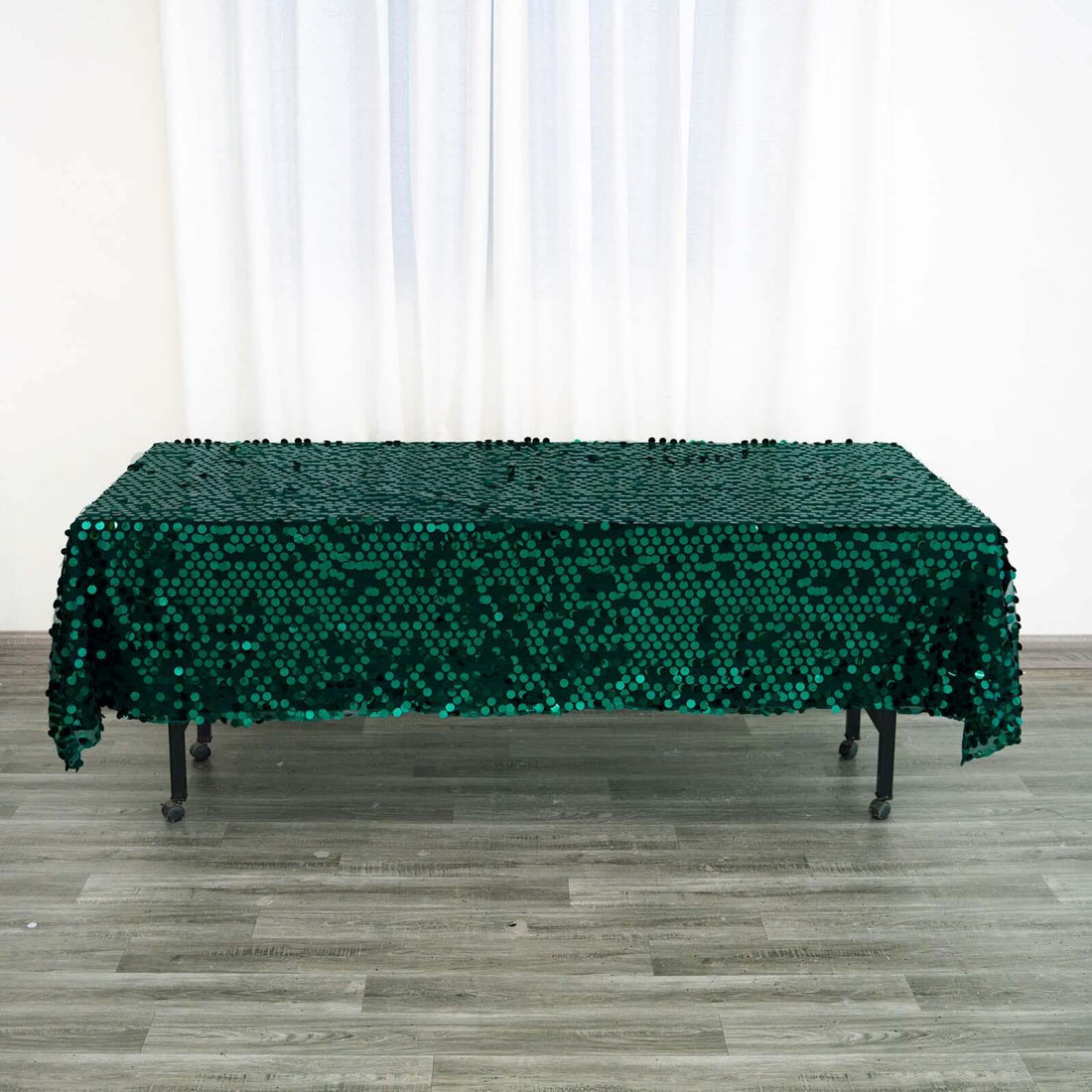 Green sequin tablecloth on a table in a bright indoor setting.