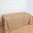 Gold sequin tablecloth on a wooden table against a white wall background.