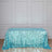 Sequin tablecloth in turquoise shades on a wooden floor.